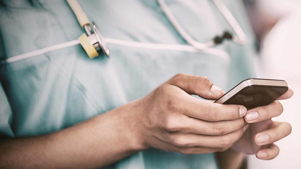 Nurse using phone close up